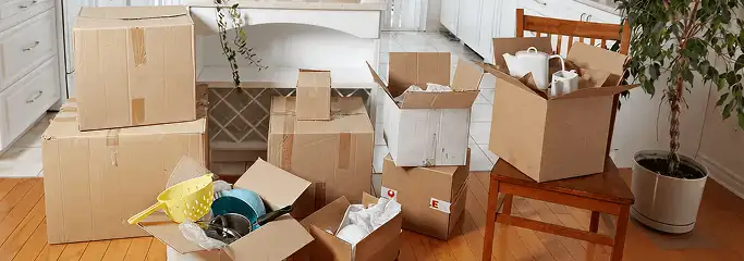 Packed moving boxes and household items in a kitchen before move-out or move-in cleaning, Colorado Springs, CO.